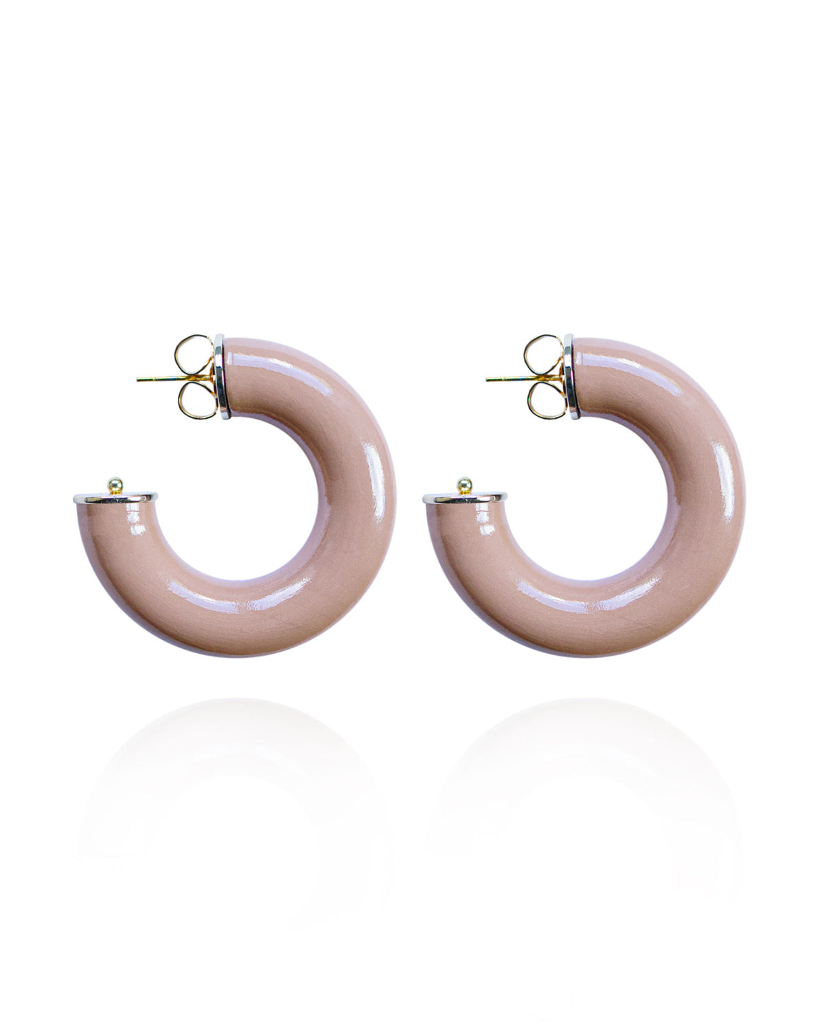 Pair of beige hoop earrings on a white background