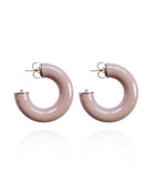 Pair of beige hoop earrings on a white background